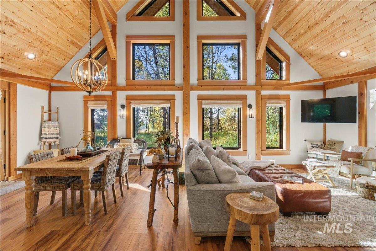Sunroom featuring lofted ceiling and a chandelier