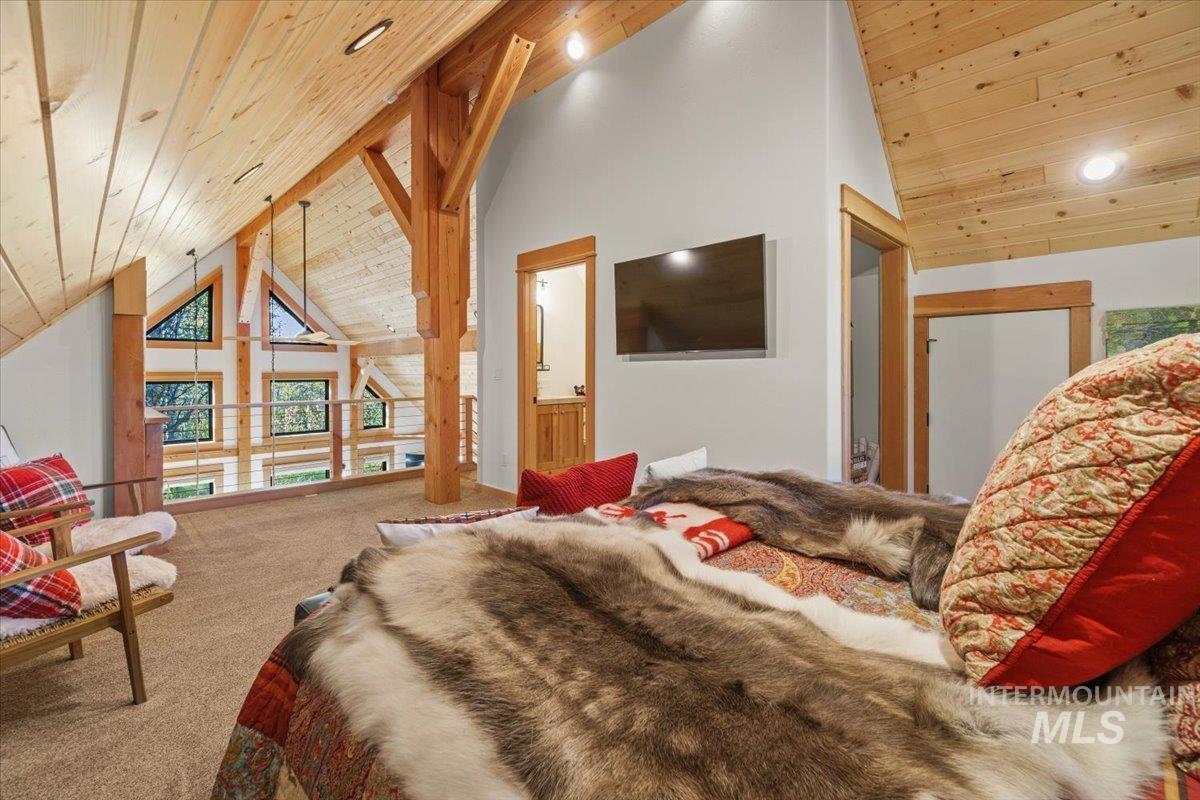Carpeted bedroom featuring wooden ceiling, high vaulted ceiling, and recessed lighting