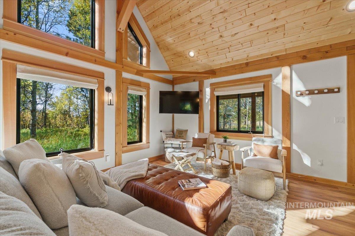 Living area featuring wood finished floors, high vaulted ceiling, wood ceiling, and recessed lighting