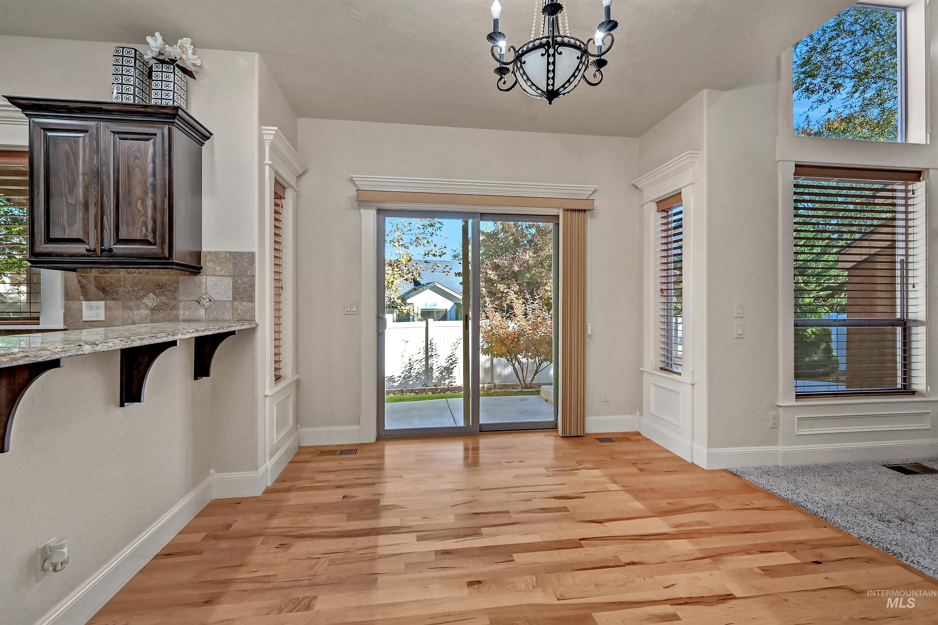 Entrance foyer with a chandelier and light wood finished floors