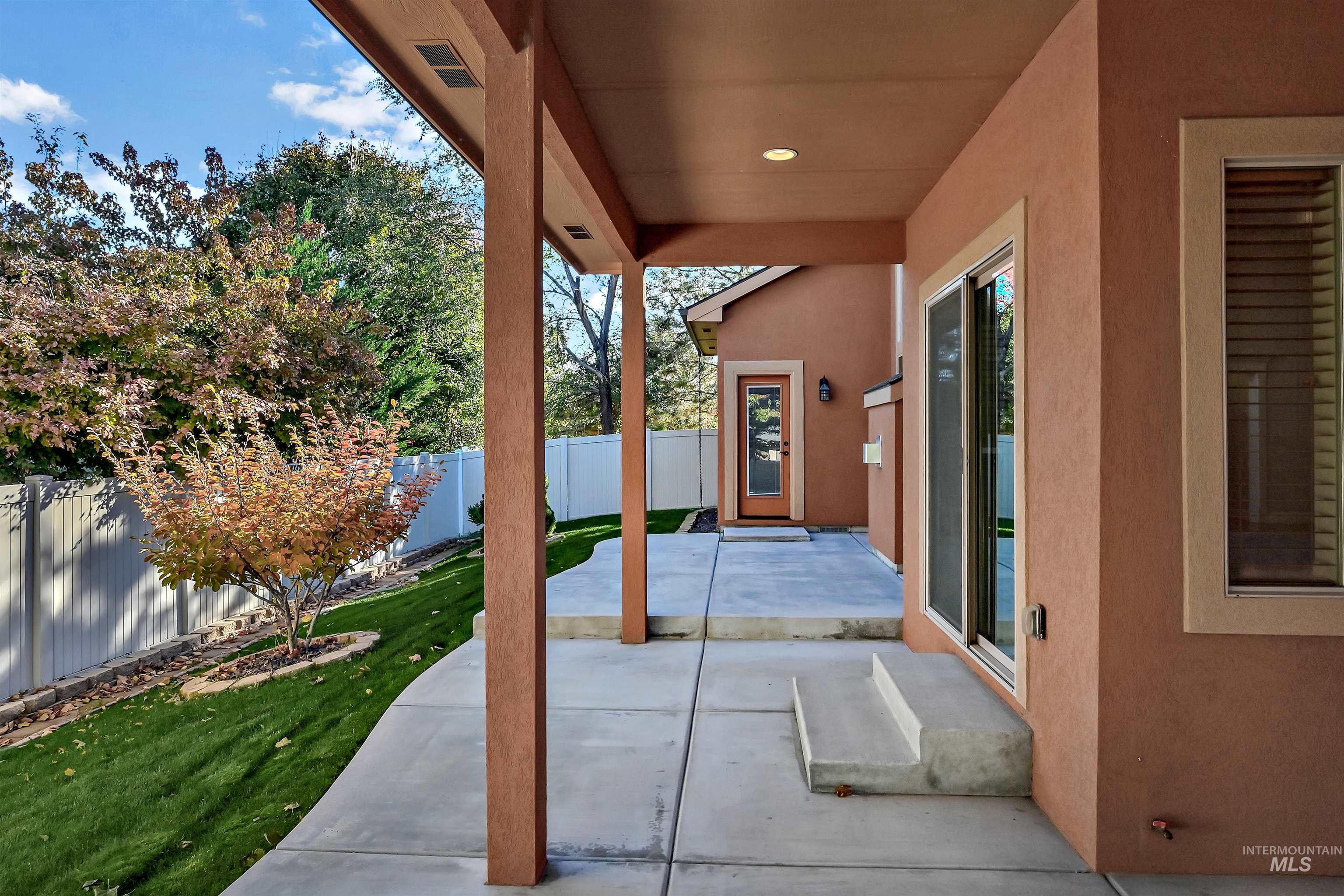 Fenced backyard with a patio