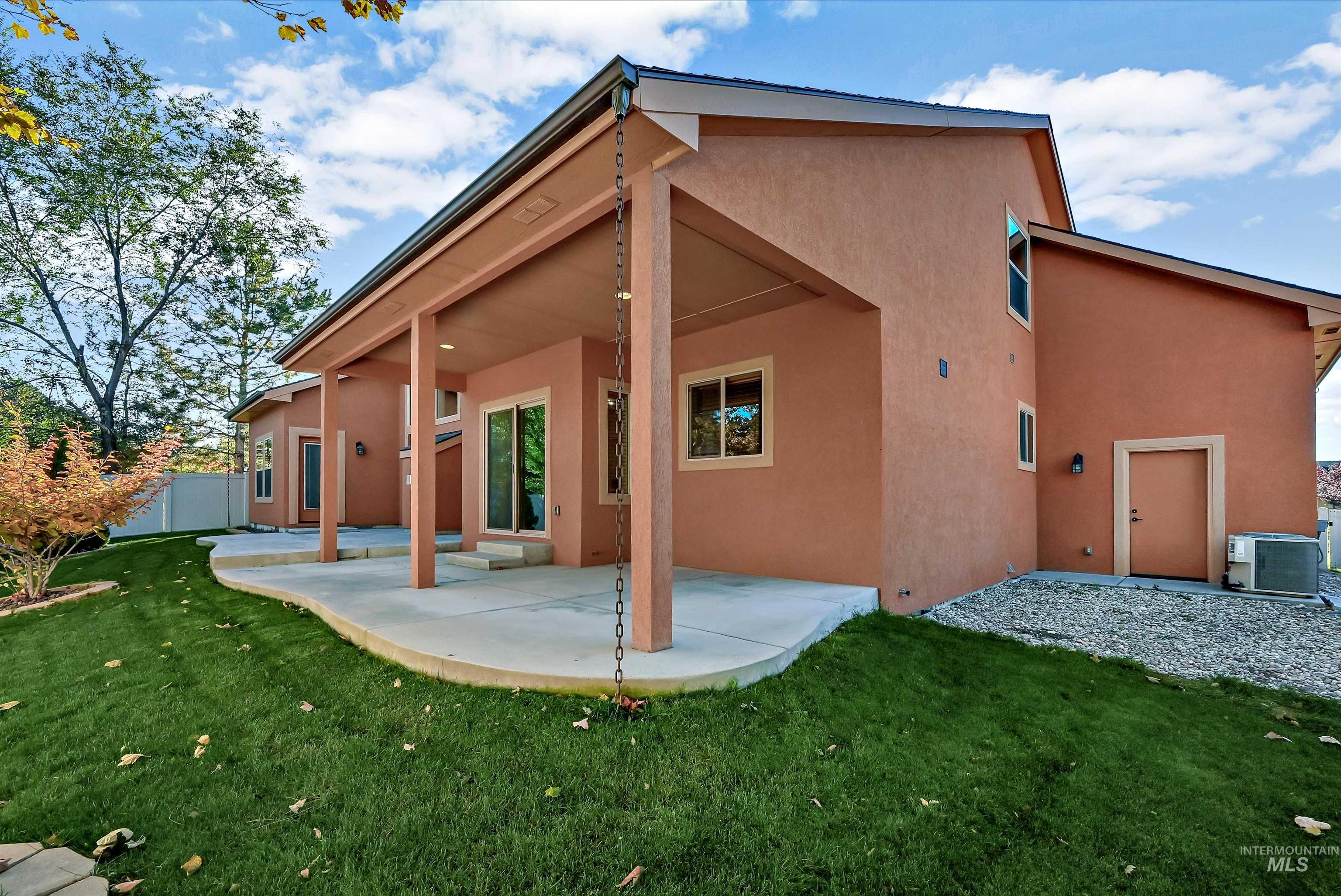Back of house featuring stucco siding and a patio