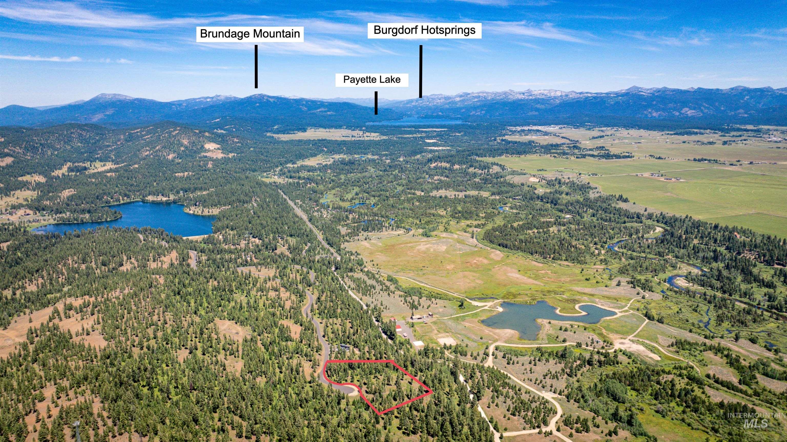 Aerial overview of property's location with a water and mountain view and property boundaries highlighted