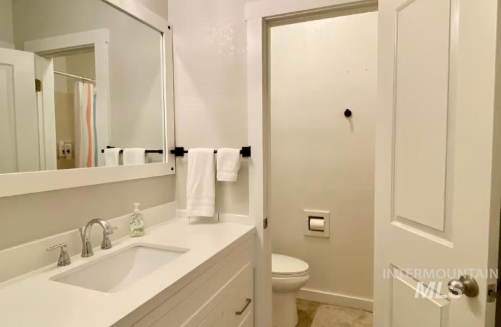 Bathroom with vanity and a shower with shower curtain
