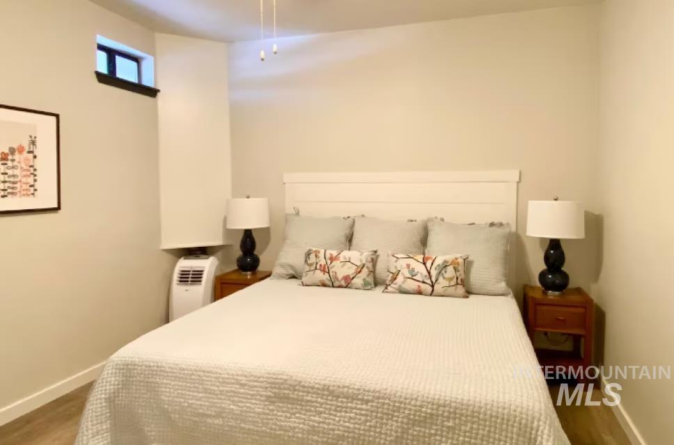 Bedroom with dark wood finished floors