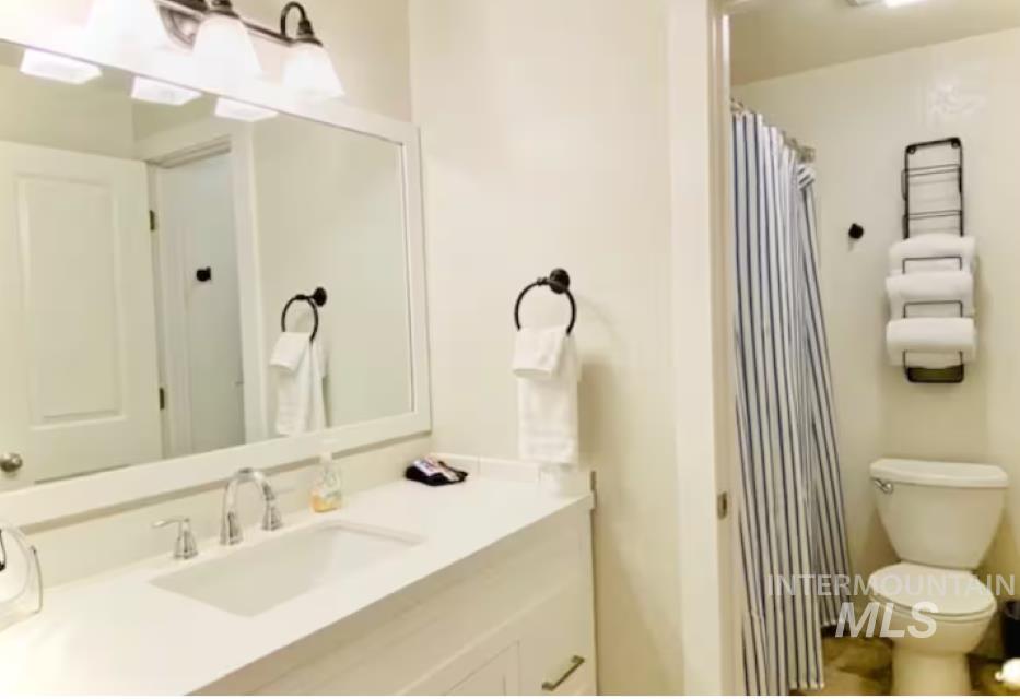 Full bath featuring vanity and a shower with curtain