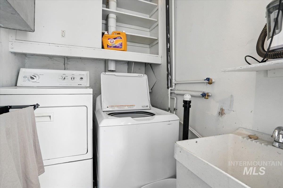 Washroom featuring washing machine and dryer