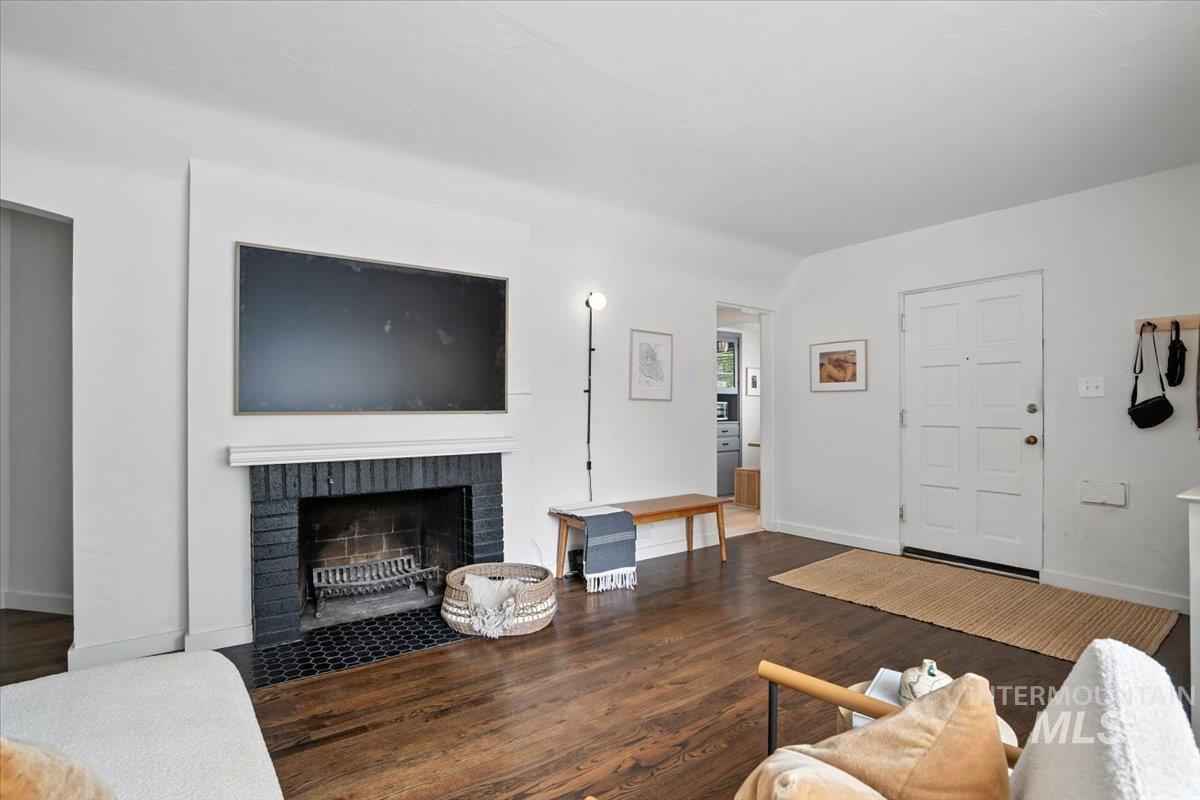 Living area with wood finished floors and a fireplace