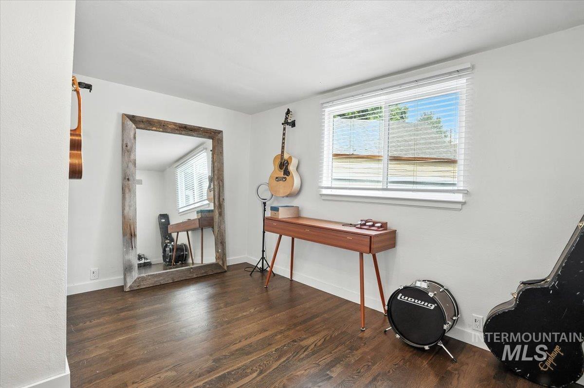 Office area with dark wood finished floors and baseboards