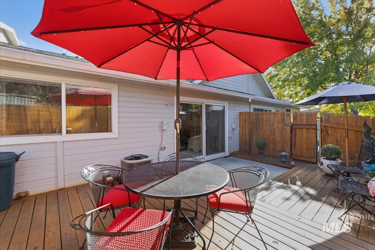 Deck featuring outdoor dining space and a gate