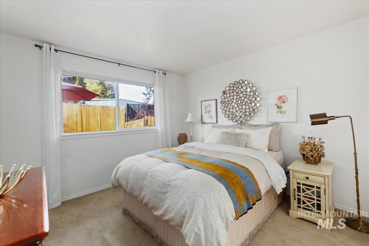 Carpeted bedroom featuring baseboards