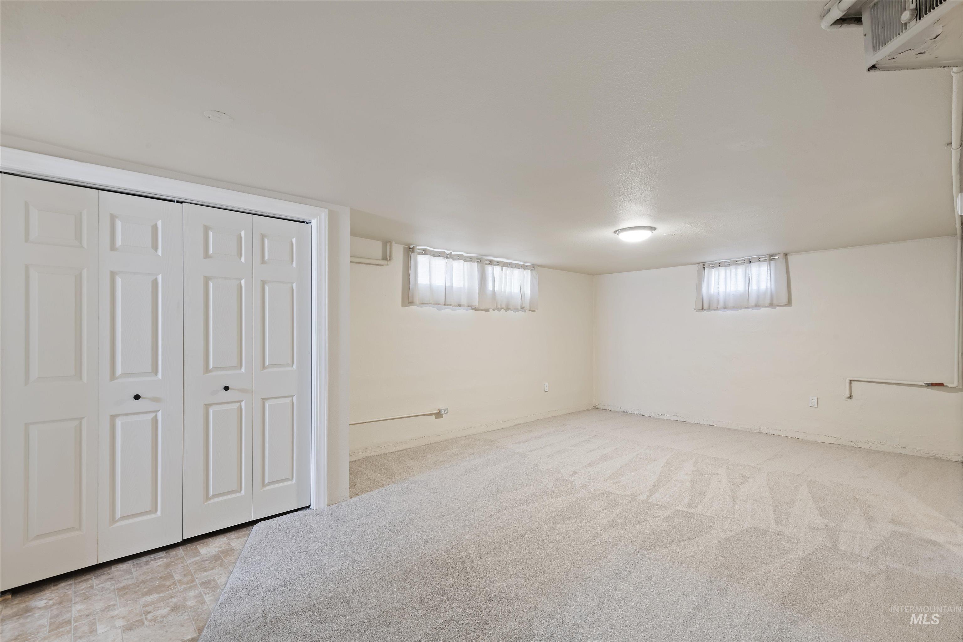 Below grade area featuring light carpet