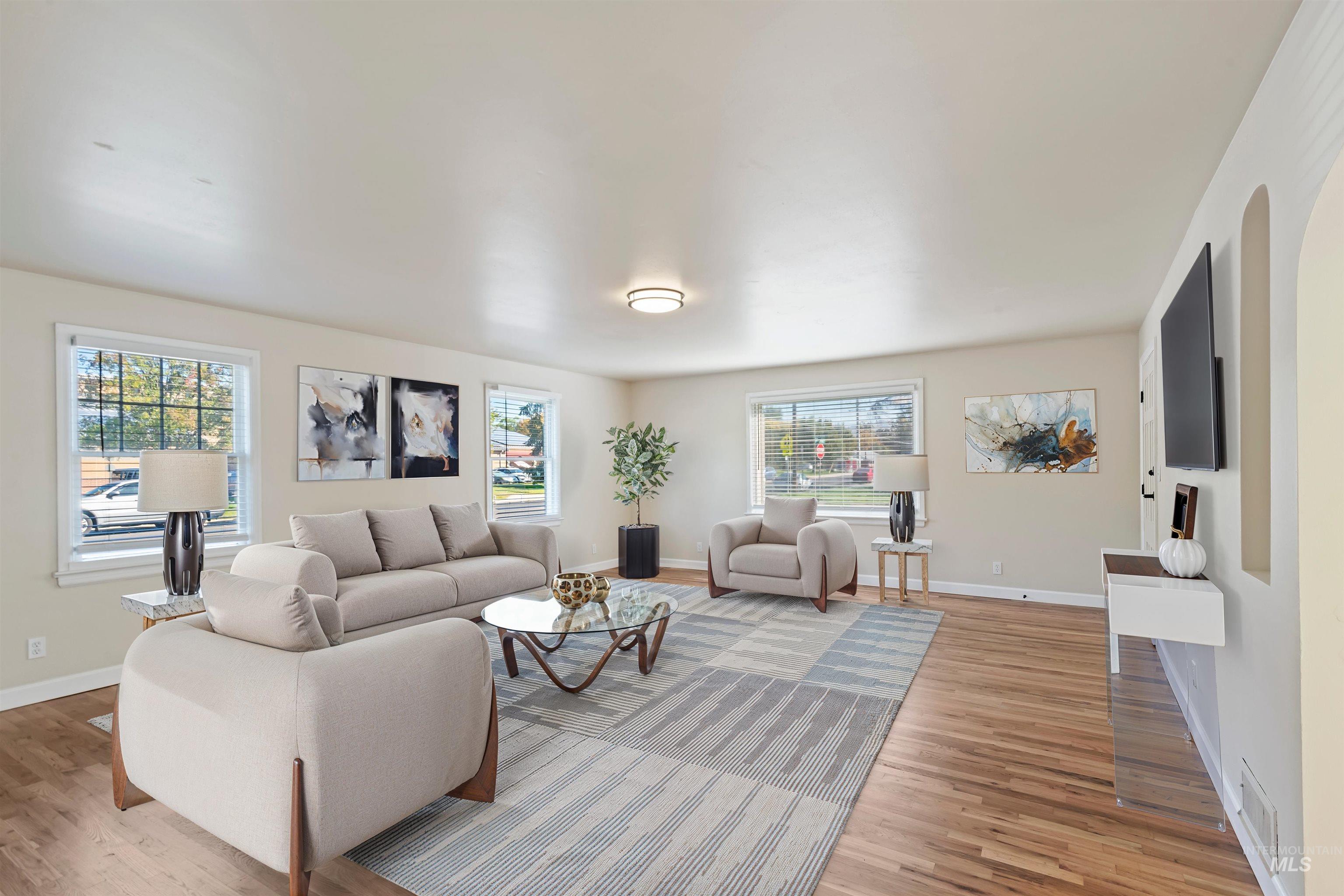 Living room with light wood-style flooring and plenty of natural light