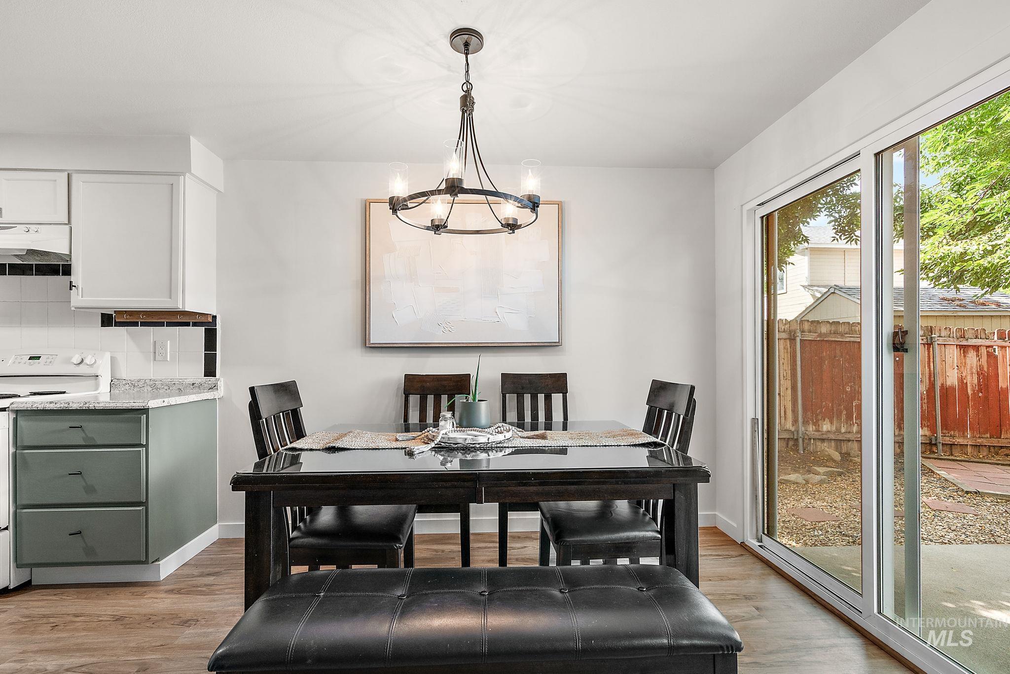 Dining area featuring light wood finished floors and a chandelier