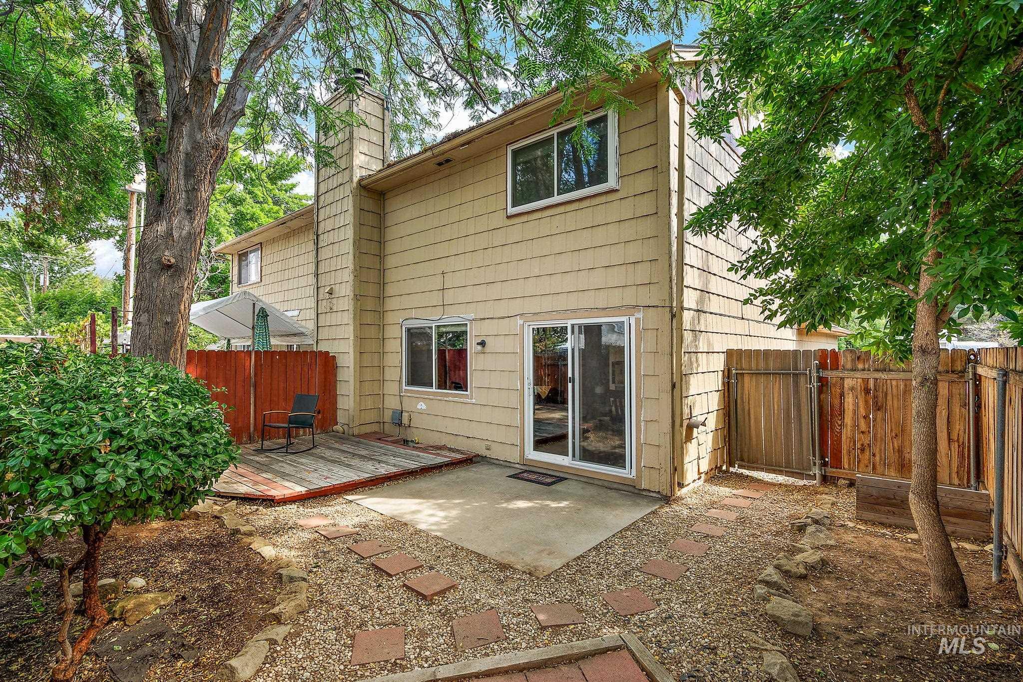 Rear view of property featuring a chimney and a patio