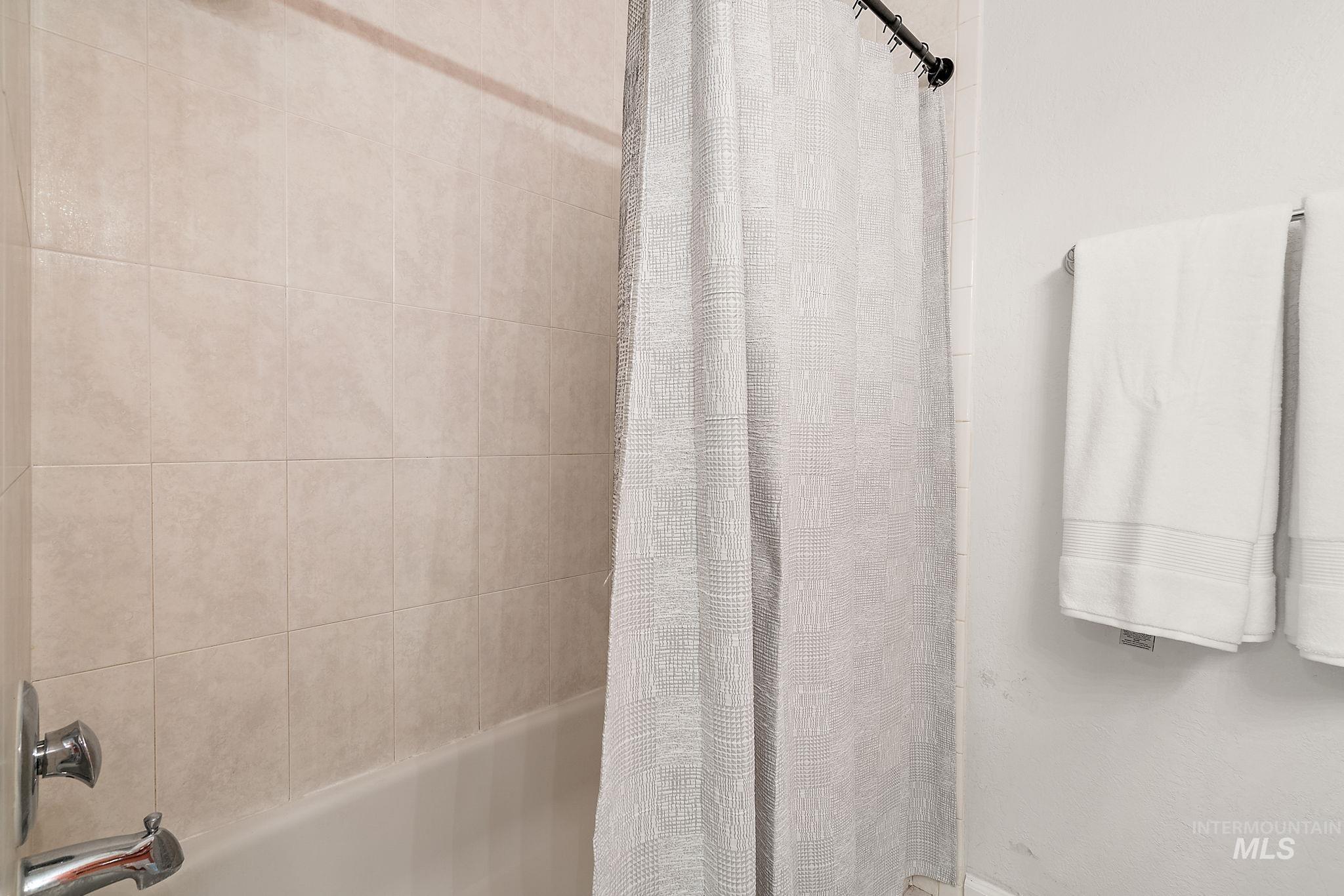 Full bath featuring shower / bath combination with curtain