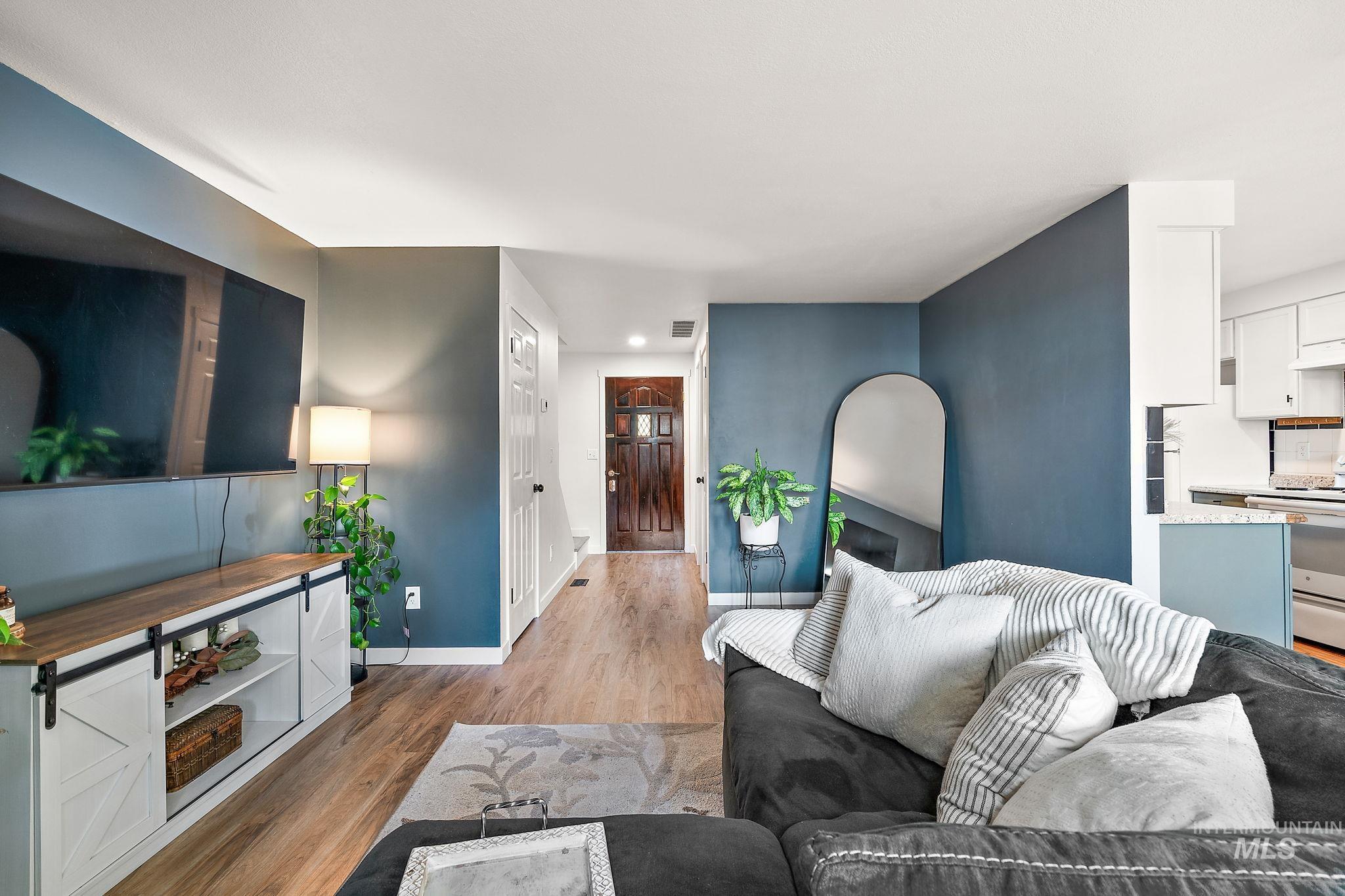 Living room featuring light wood-style flooring and baseboards