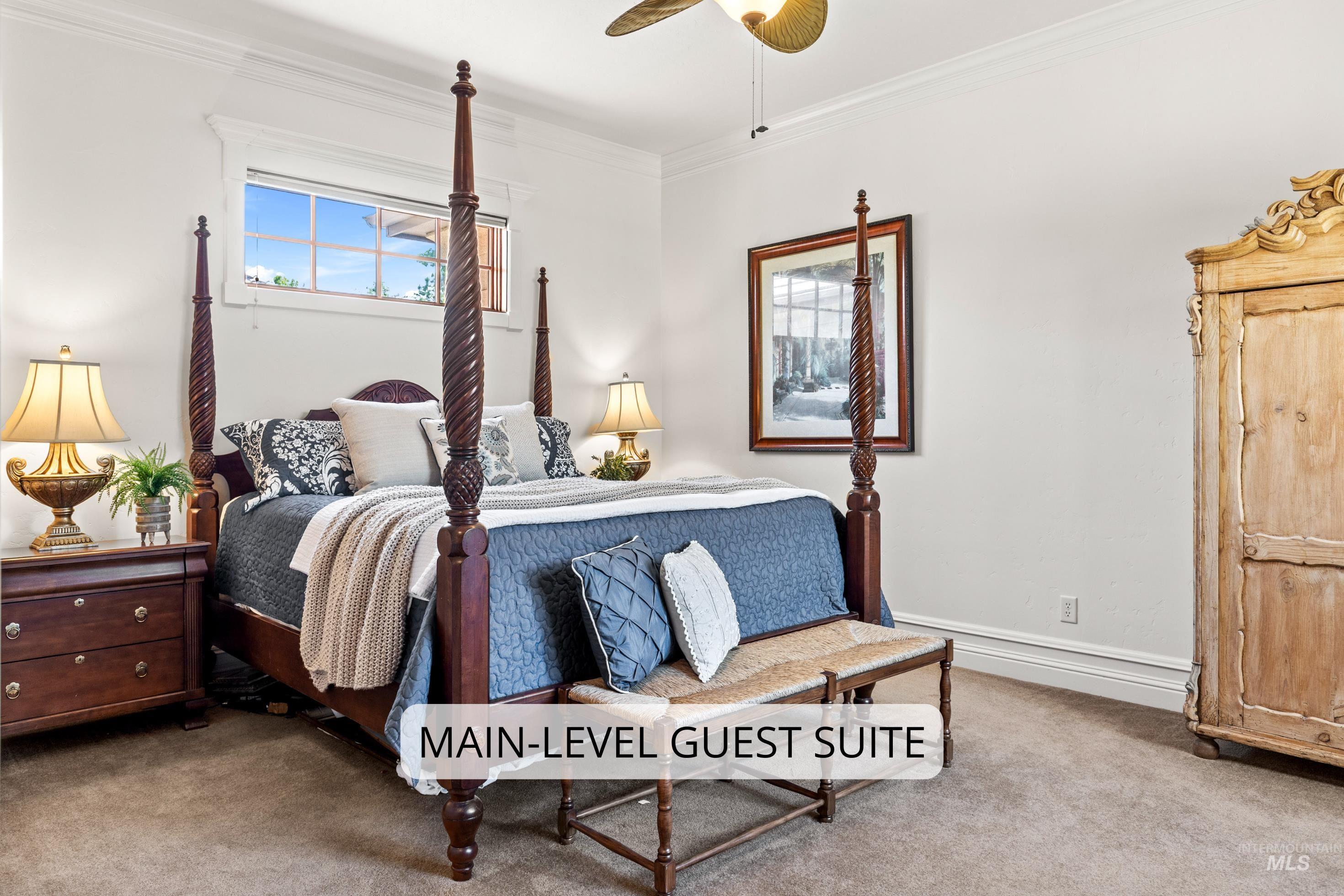 Carpeted bedroom featuring crown molding, a large window, and light-colored walls