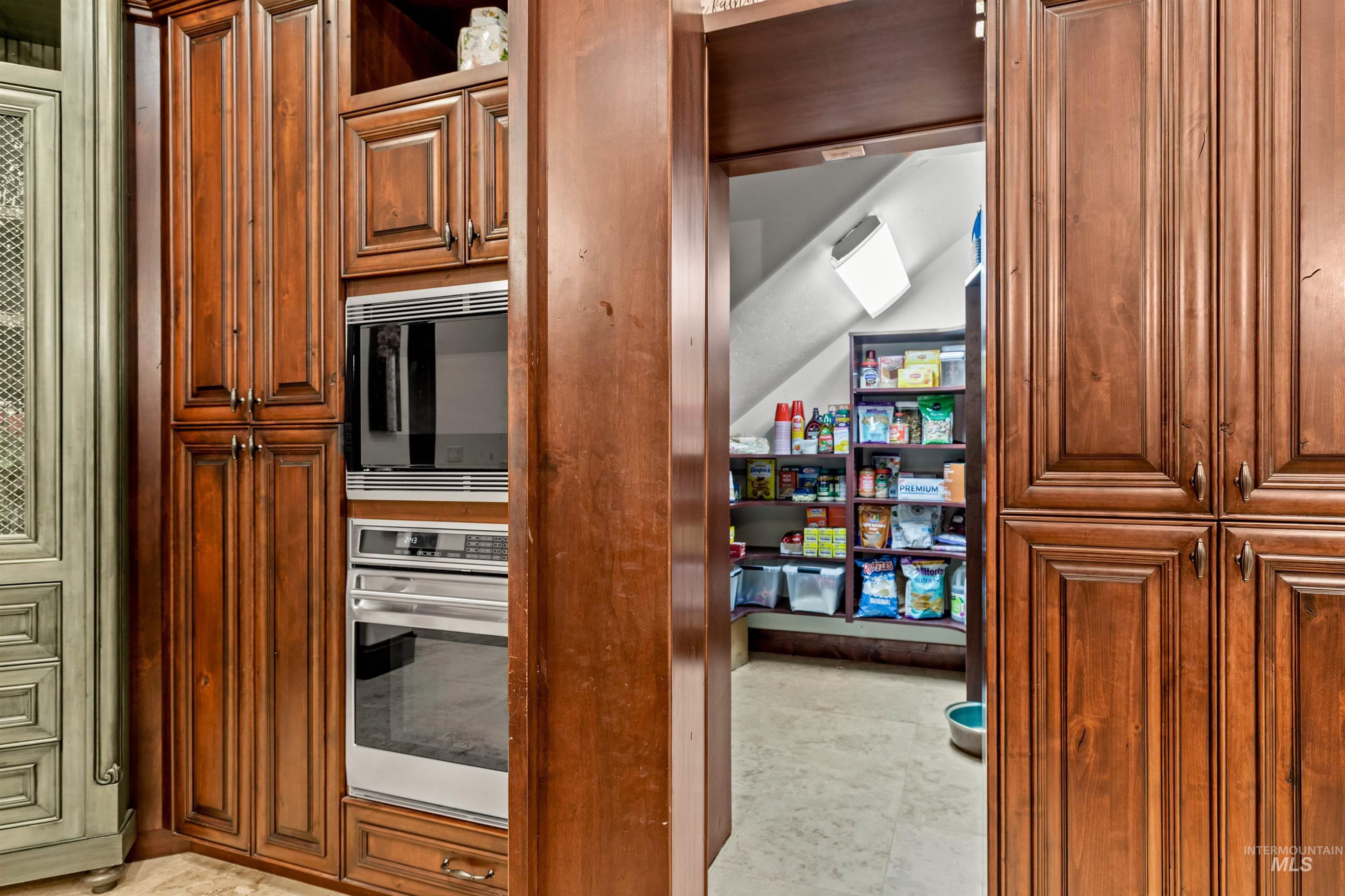 Built-in stainless steel microwave and oven combination unit within custom wood cabinetry