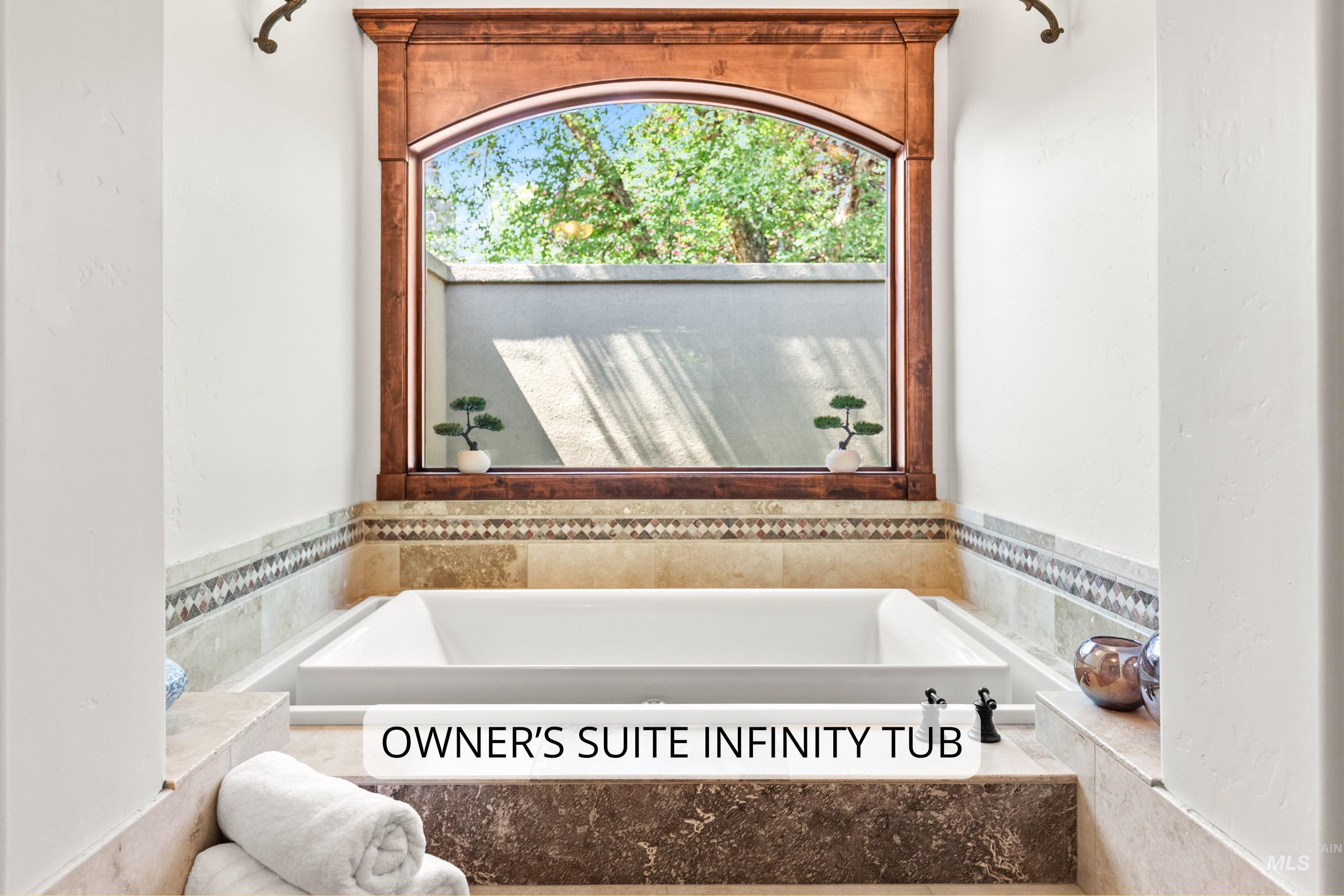 Recessed soaking tub with an arched wood-framed window