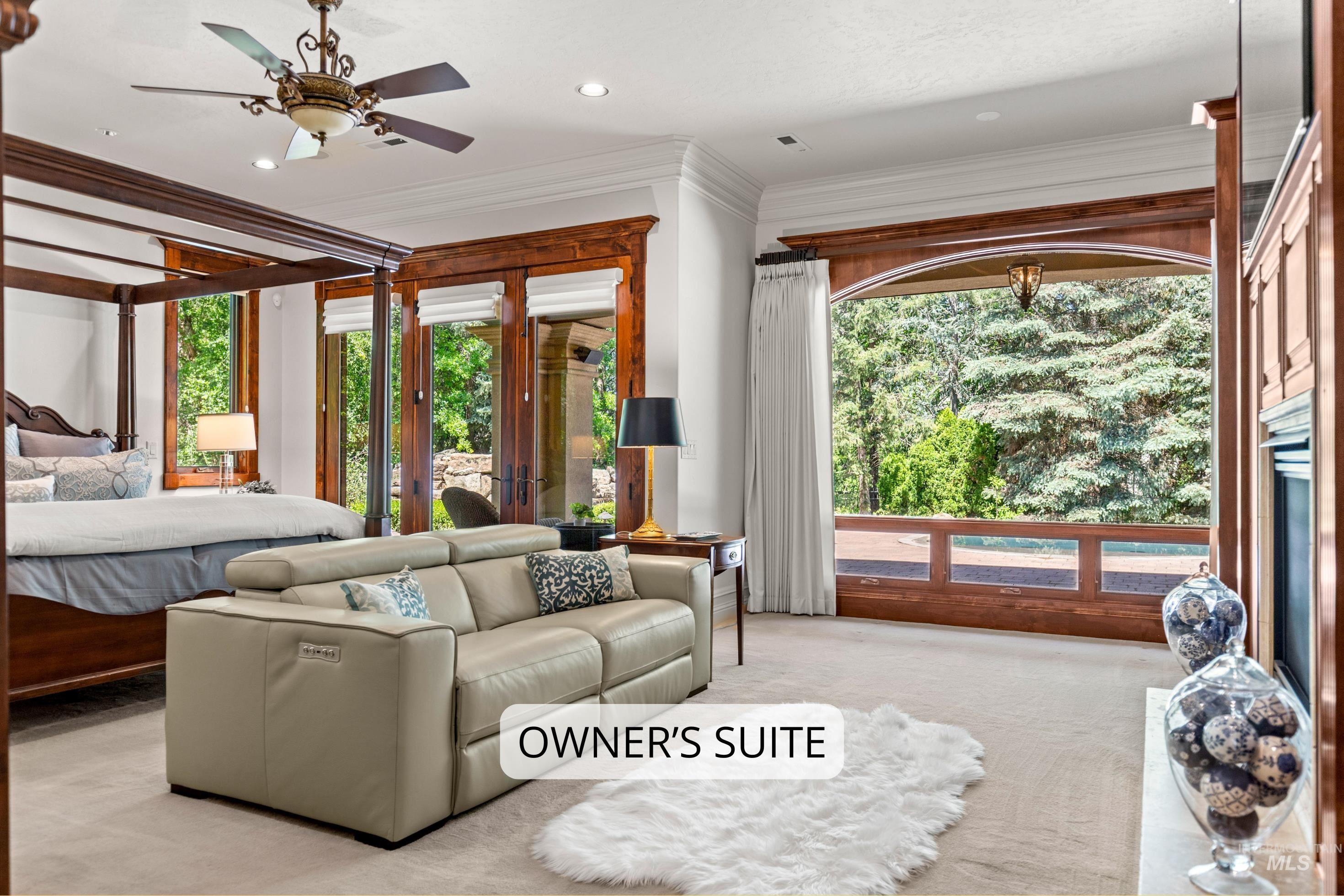 Spacious interior featuring a large picture window, ornate wood trim, recessed lighting, and a ceiling fan with integrated light
