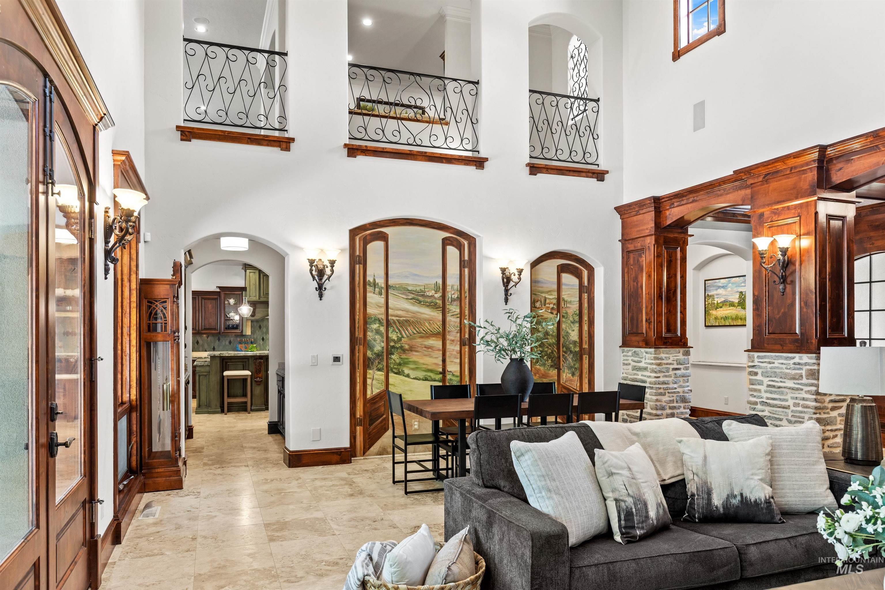 Two-story living area featuring wrought iron balconies and arched entryways