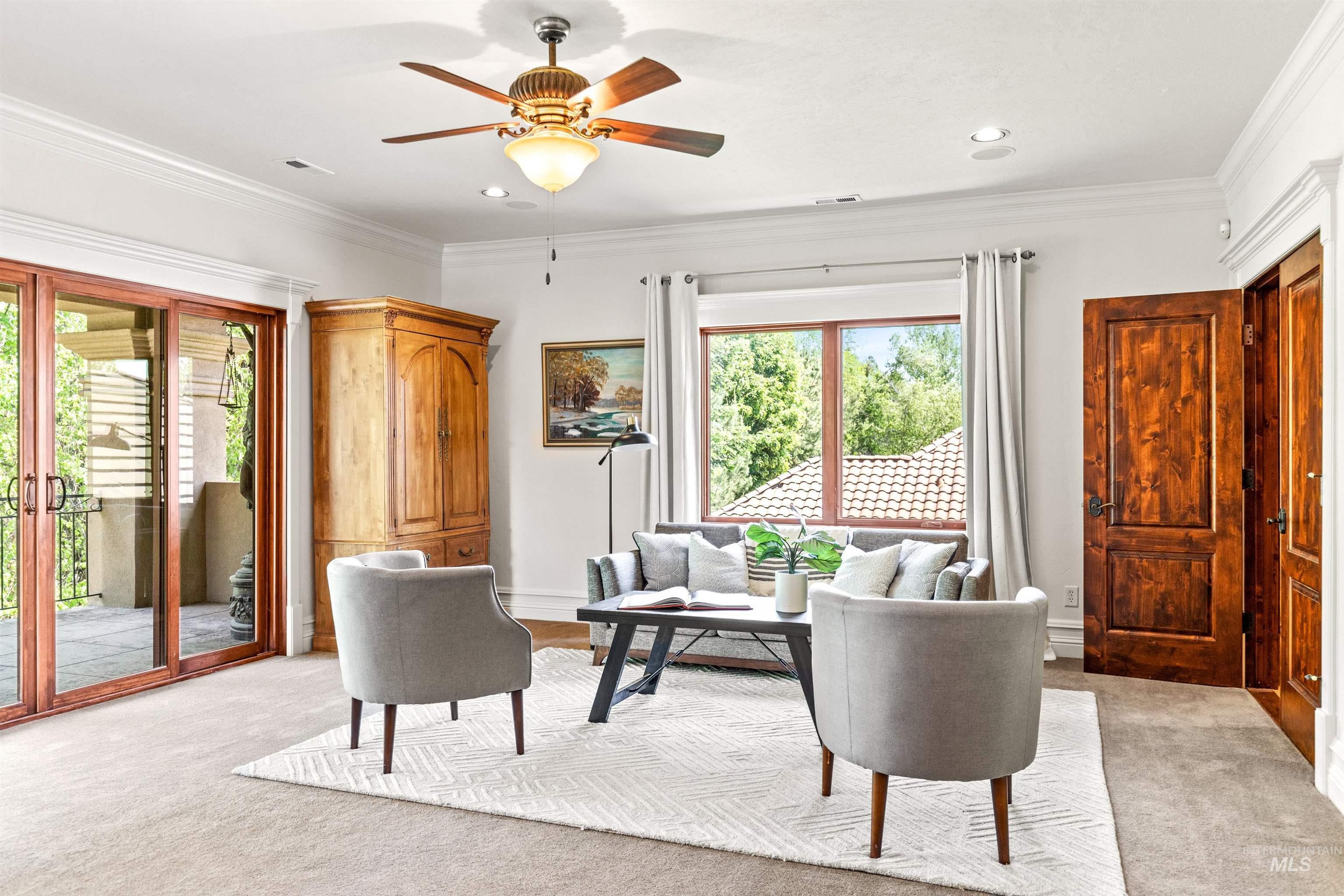 Spacious room featuring broadloom carpeting, a multi-pane window, and a glass-paneled sliding door opening to a private balcony