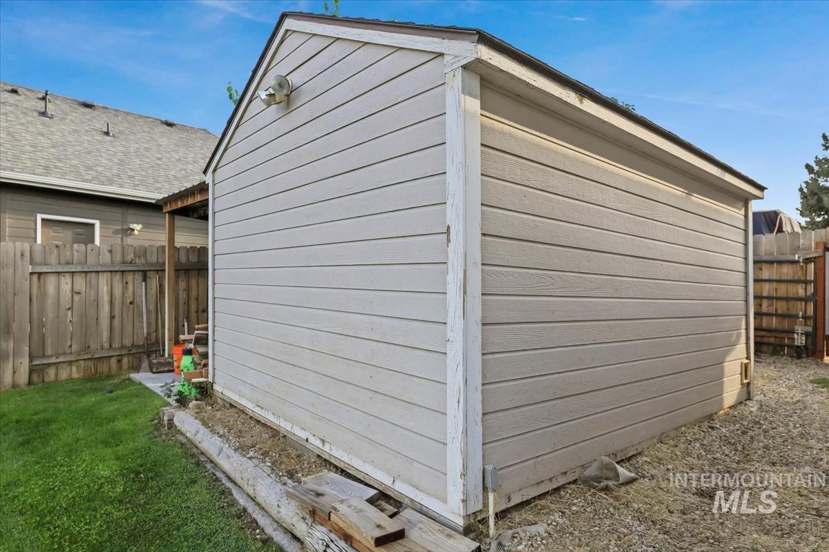 View of property exterior featuring an outbuilding