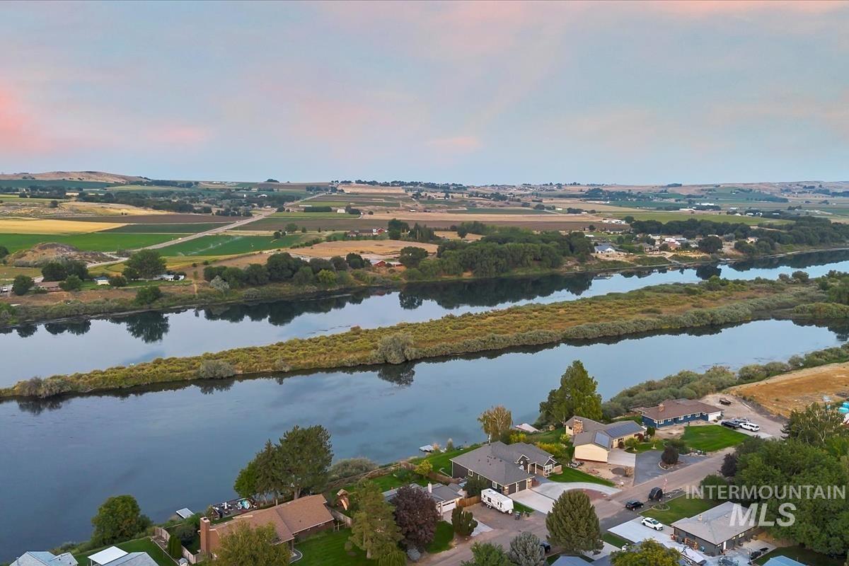 Aerial view of property and surrounding area featuring a nearby body of water