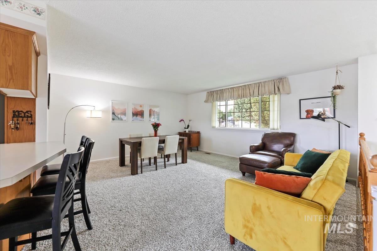 Living room featuring light carpet and baseboards