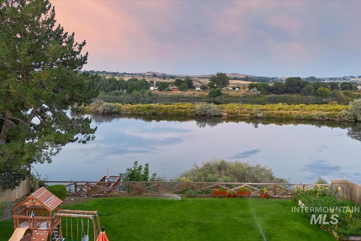 Water view with a fenced backyard