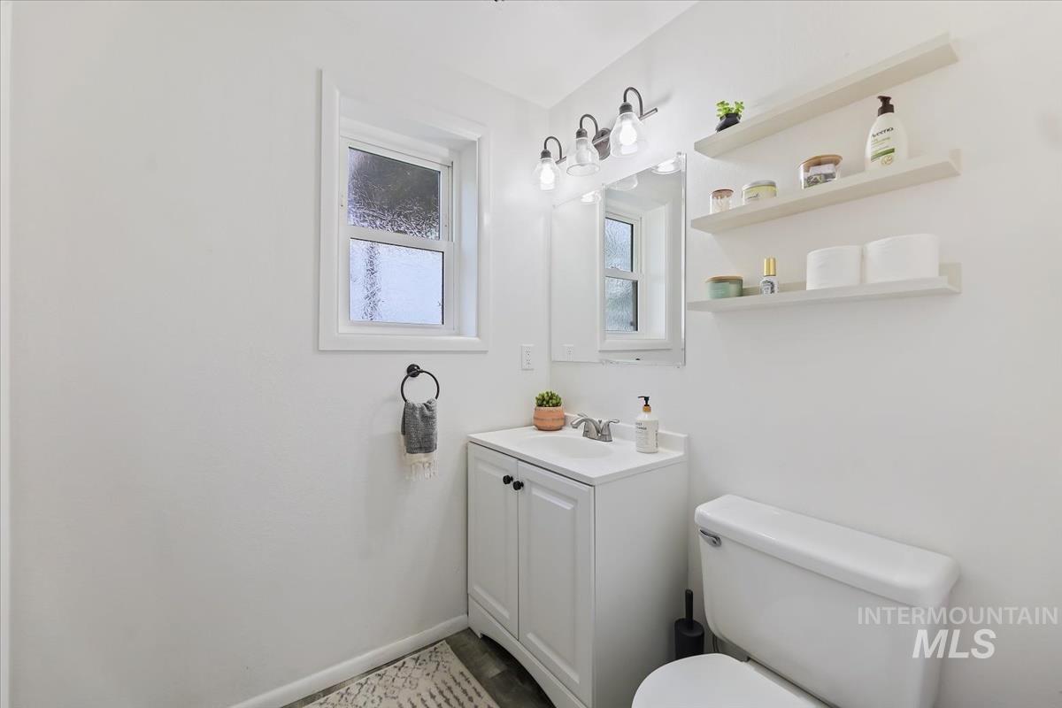 Half bathroom with vanity and toilet
