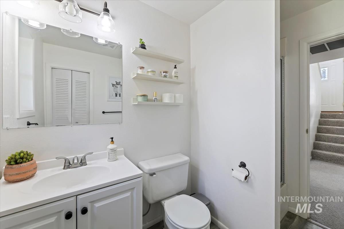 Bathroom featuring vanity and a closet