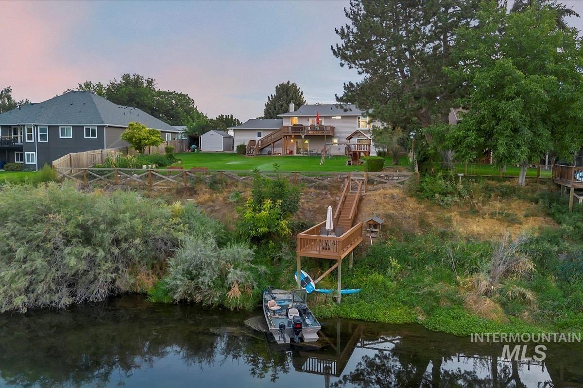 Dock featuring stairway and a deck with water view