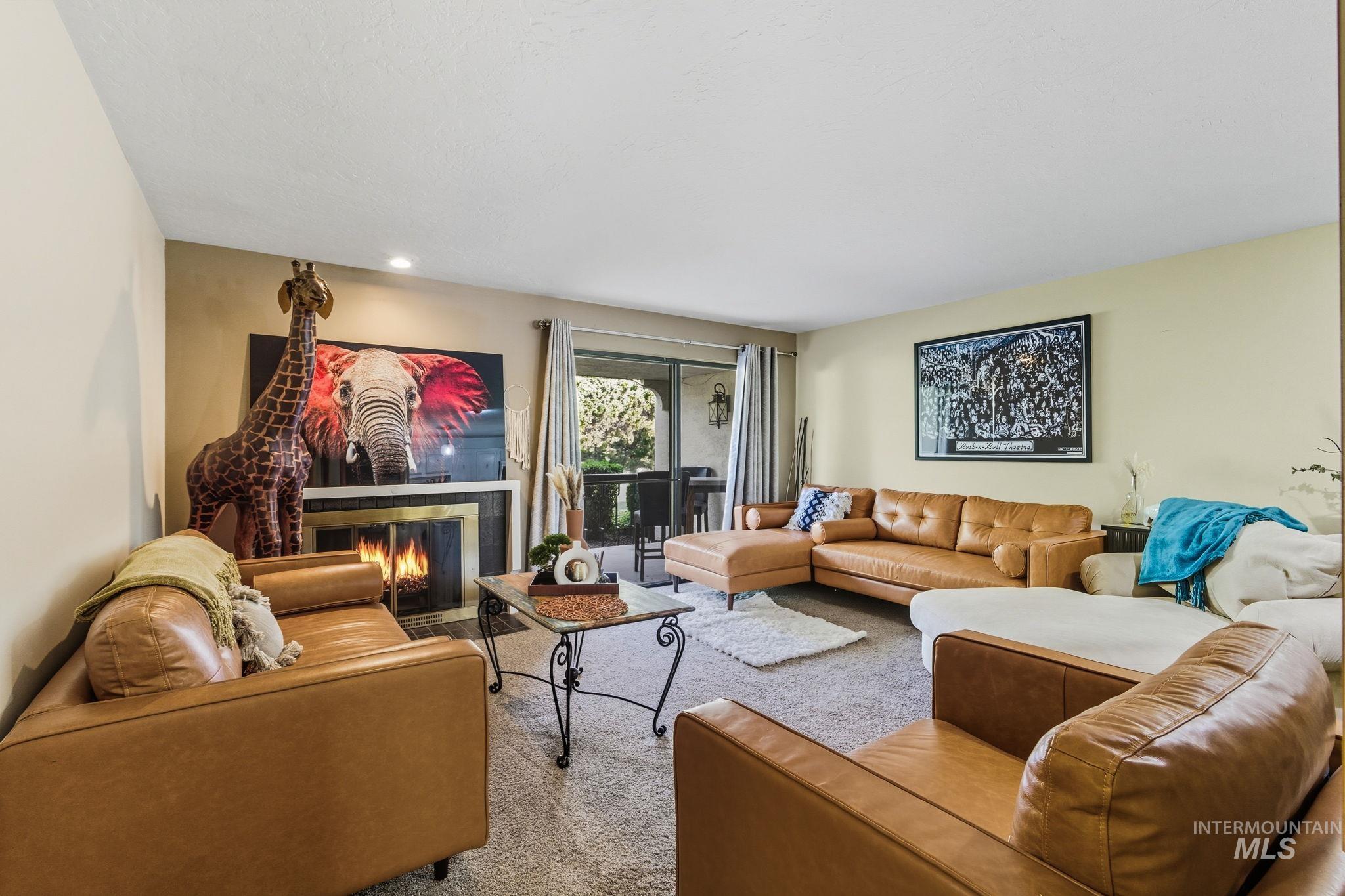 Living area featuring a fireplace and carpet floors