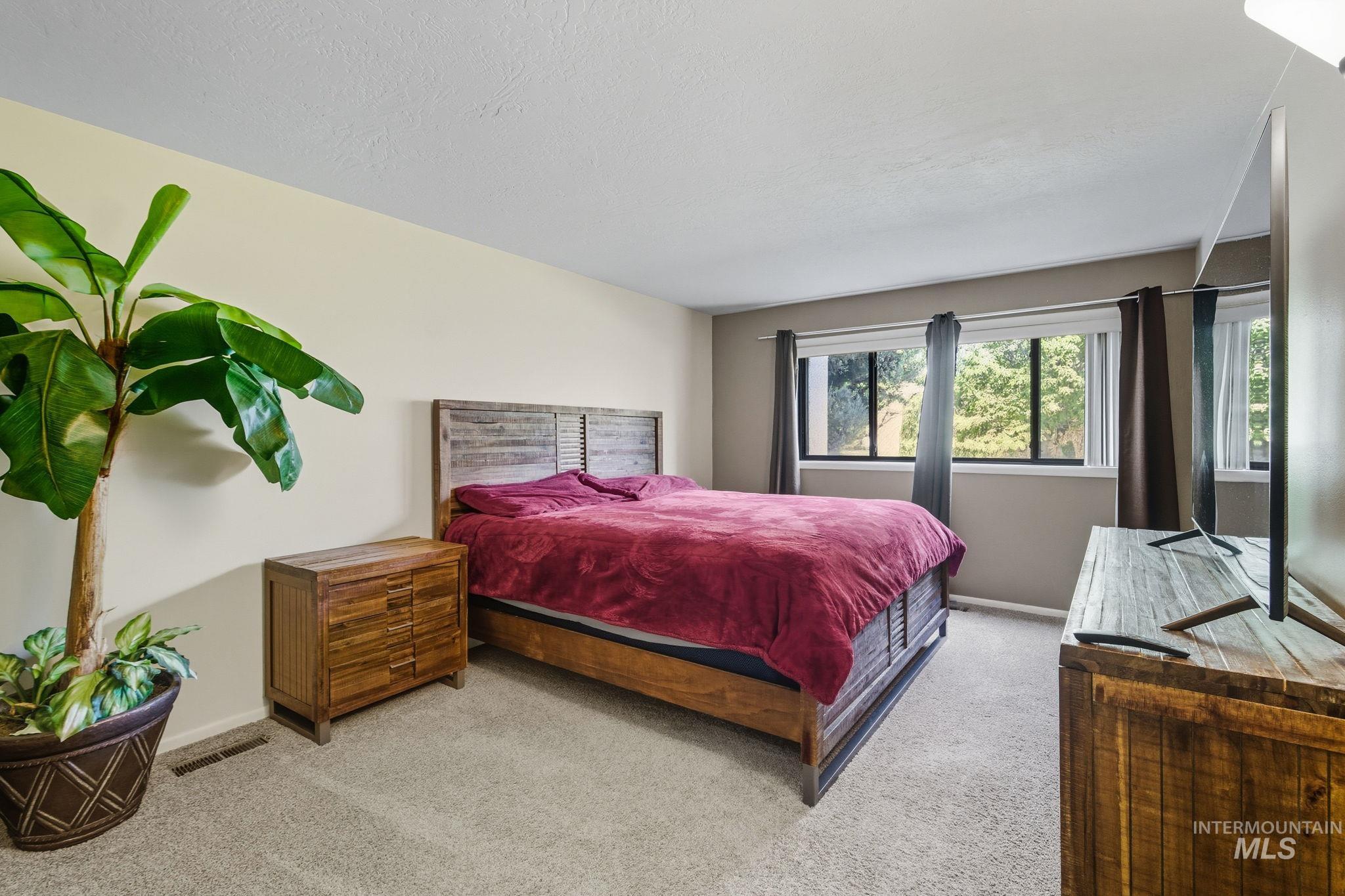 Carpeted bedroom featuring baseboards