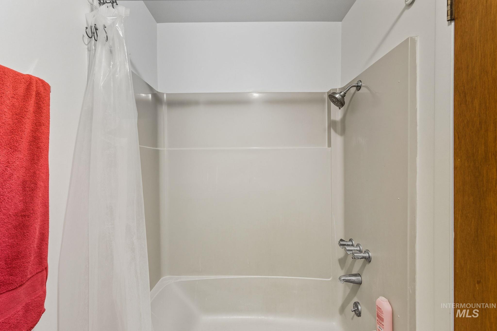 Full bath with shower / bath combination with curtain