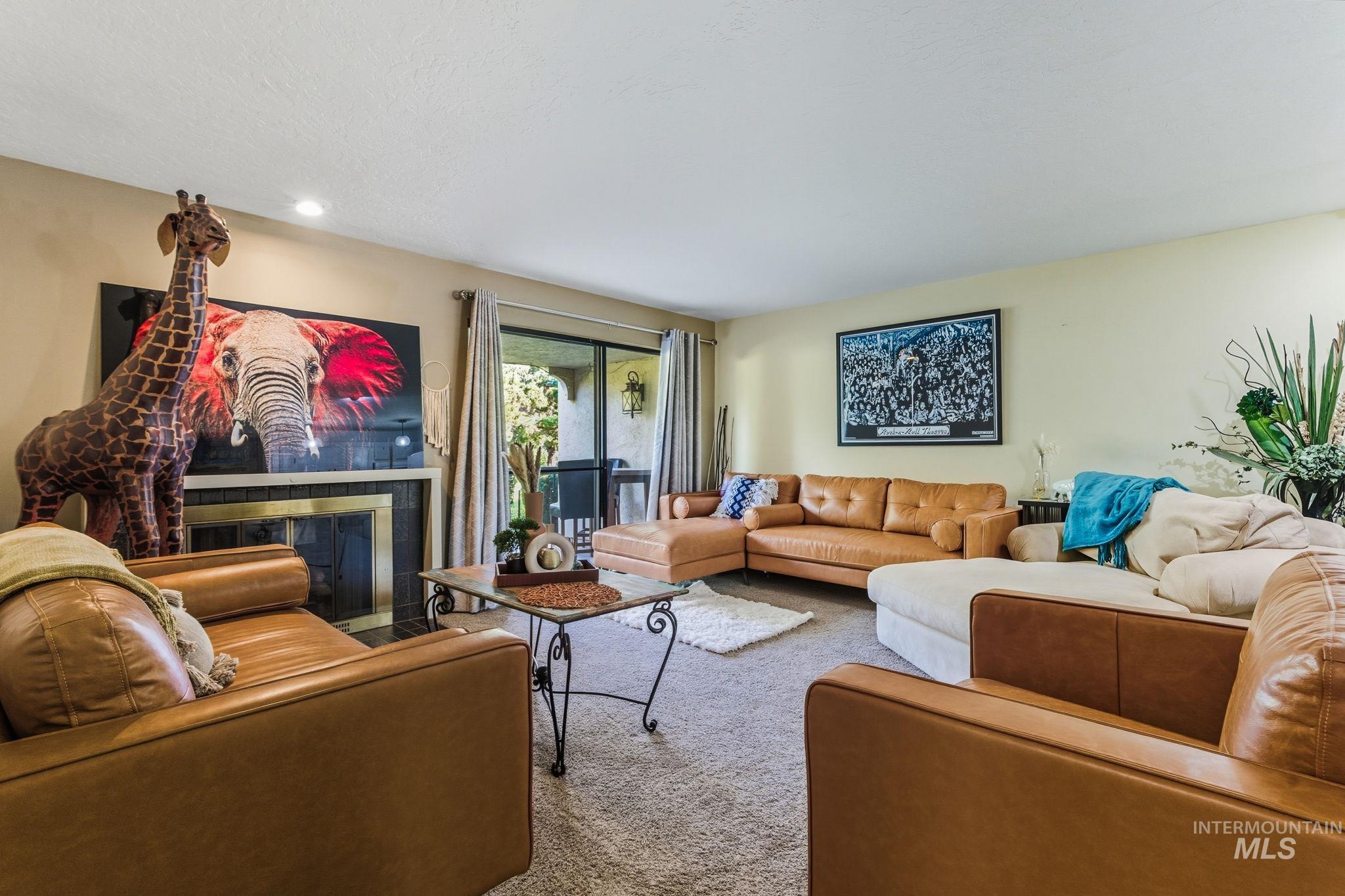 Carpeted living room with a tiled fireplace