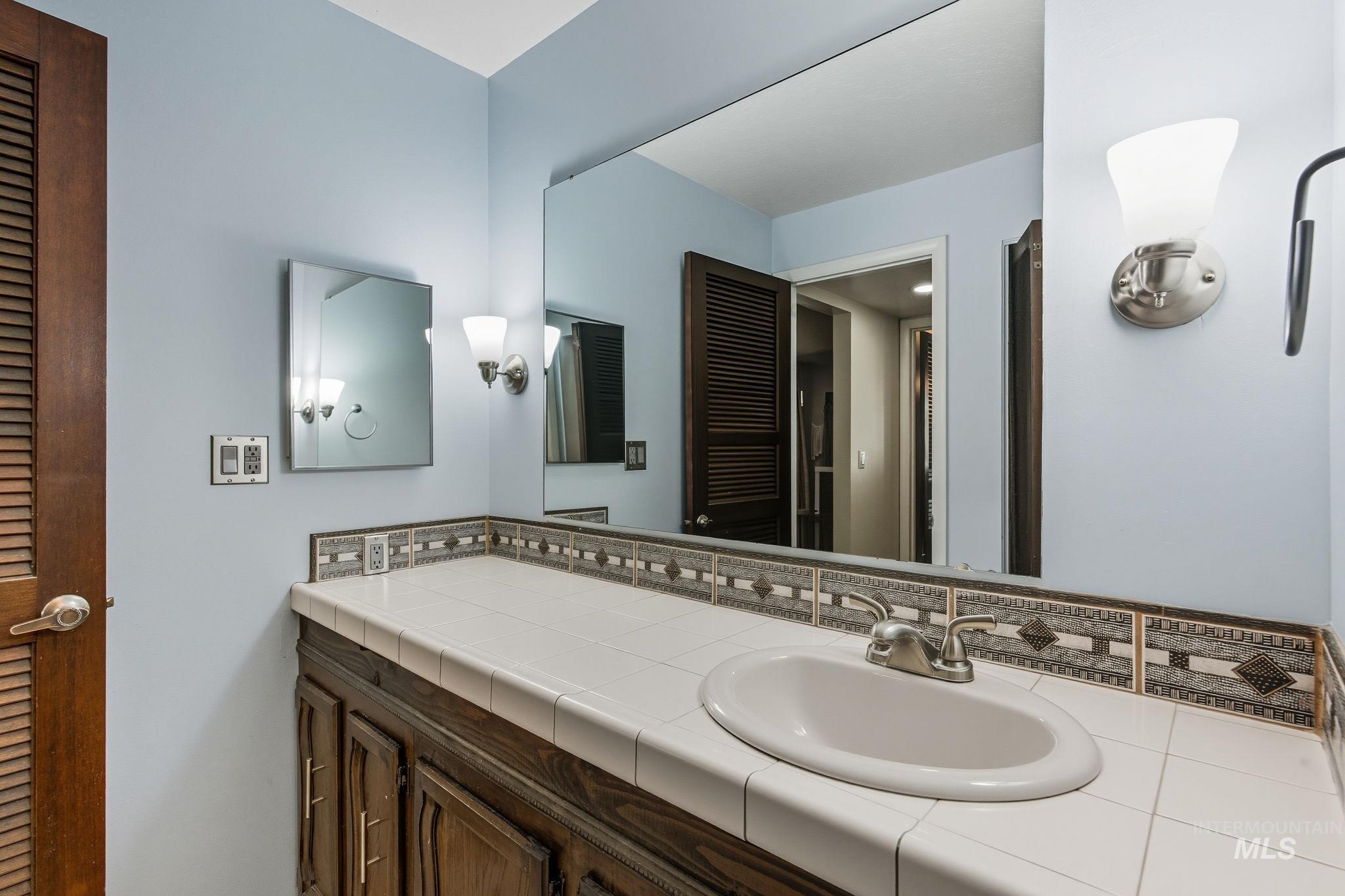 Bathroom featuring a closet and vanity