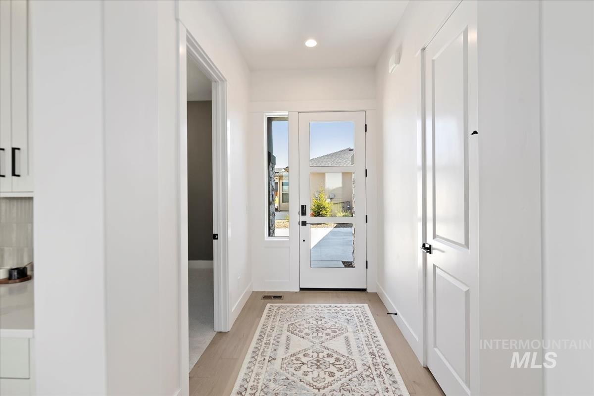 Entryway featuring wood finished floors and recessed lighting