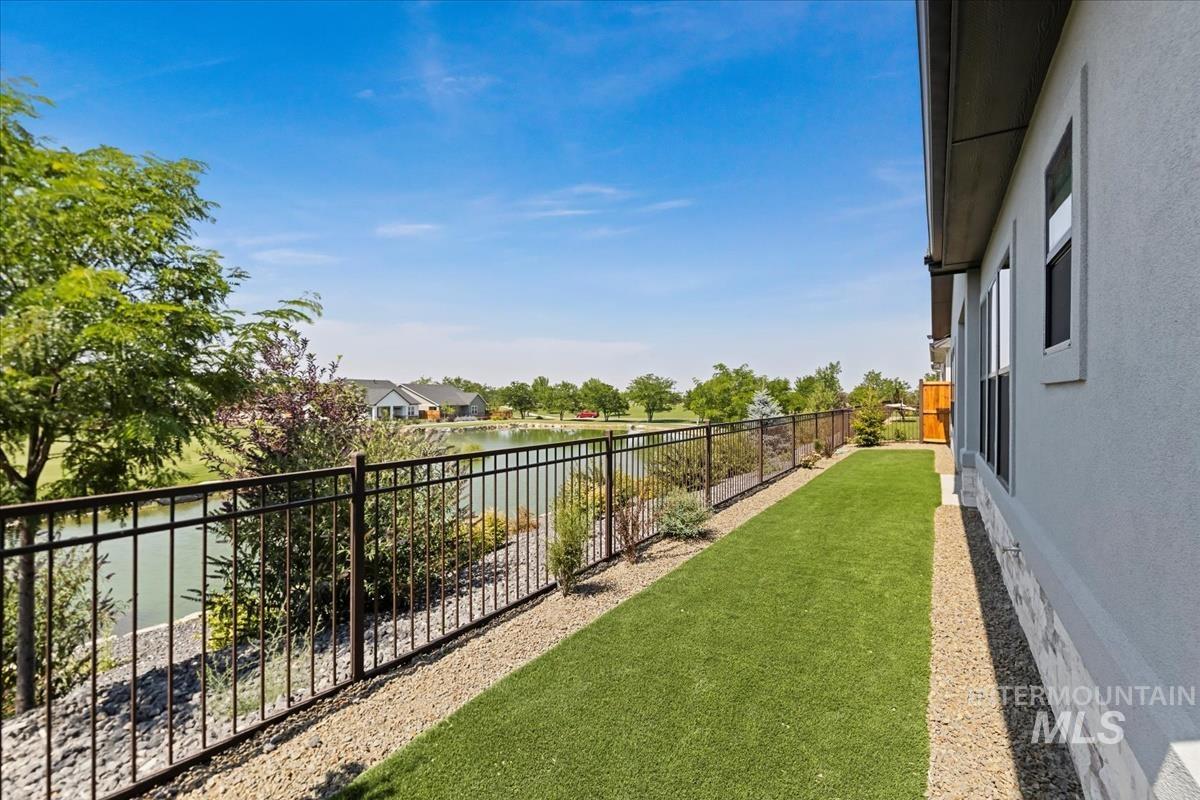 Fenced backyard featuring a water view