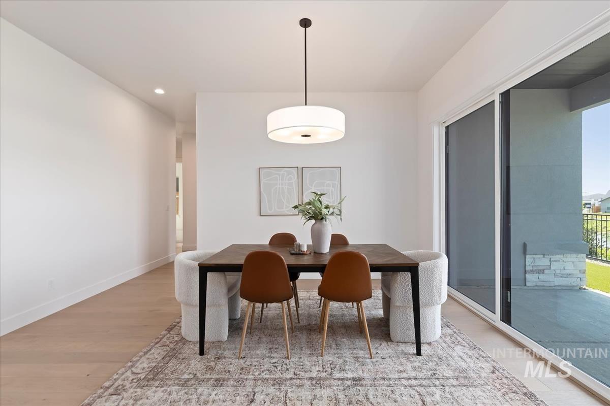 Dining space with light wood-style flooring and recessed lighting