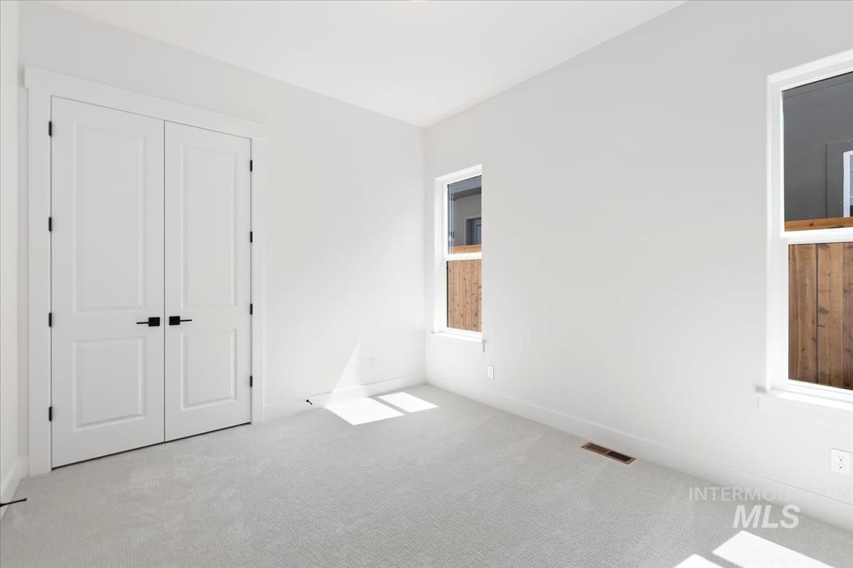 Unfurnished bedroom with carpet and a closet