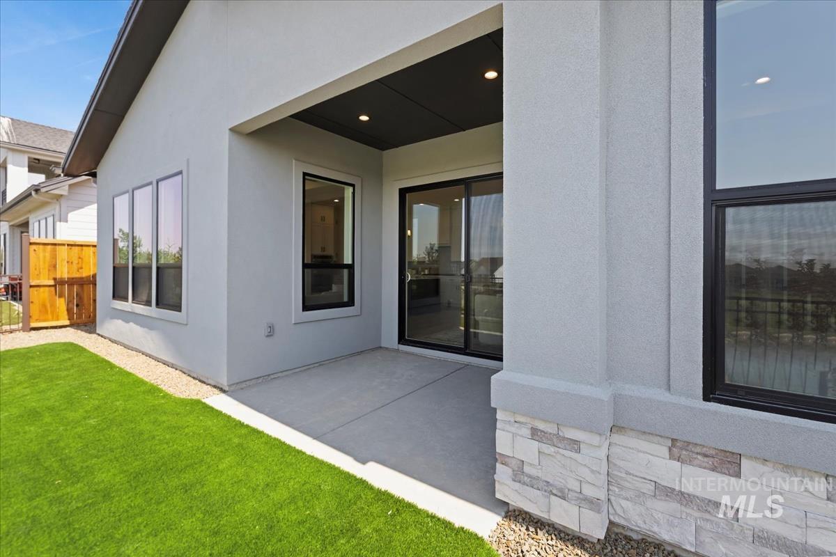 Back of property featuring a patio area and stucco siding