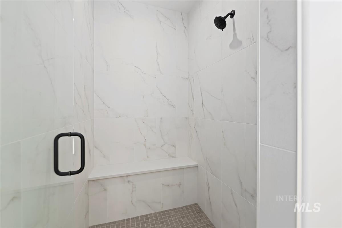 Bathroom with a marble finish shower