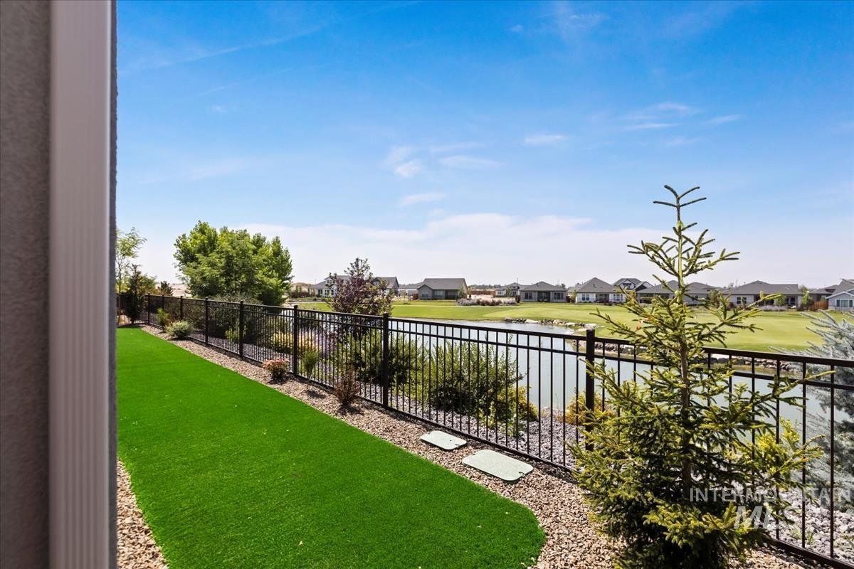 View of yard featuring a water view and a residential view