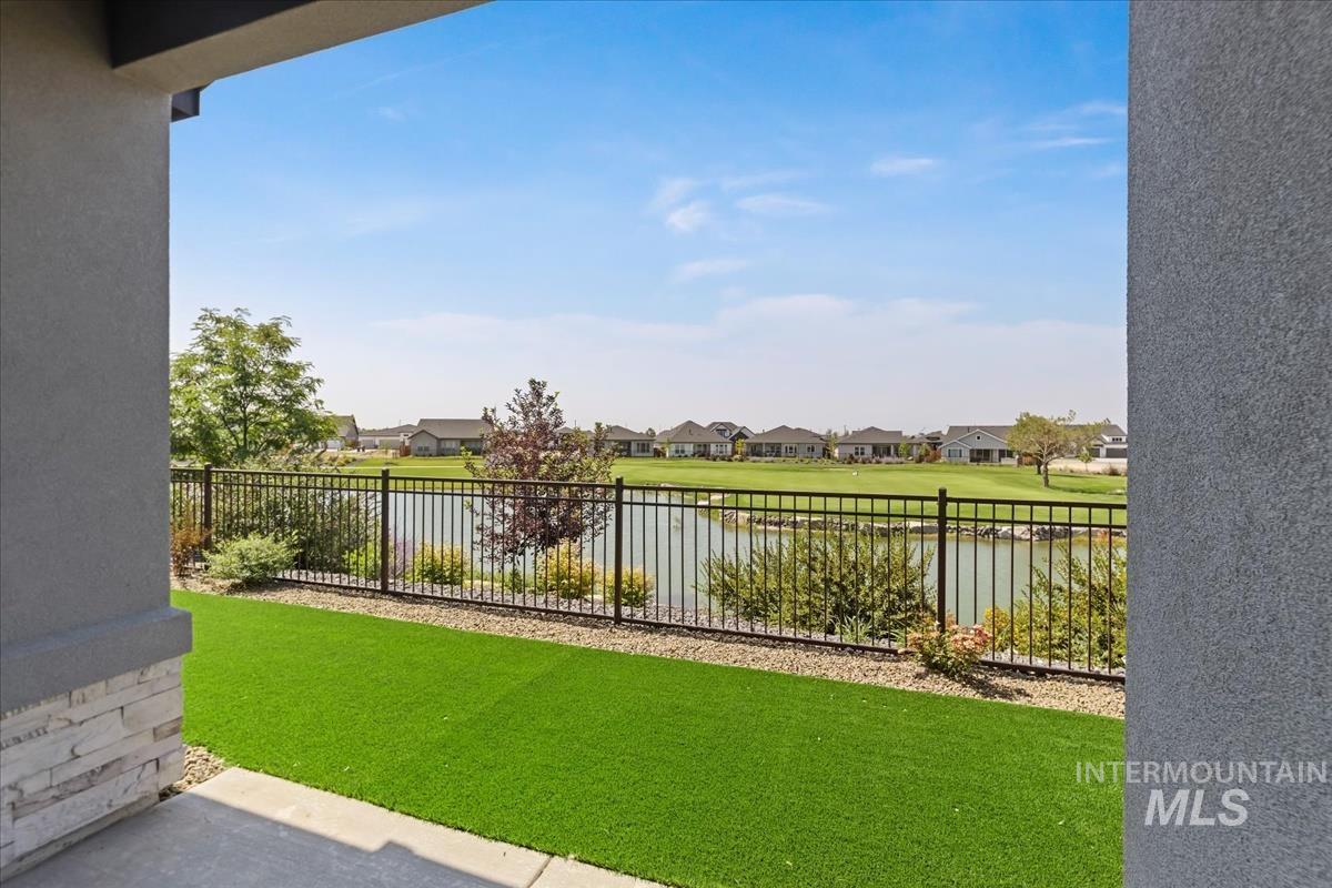View of yard with a water view, a residential view, and a patio