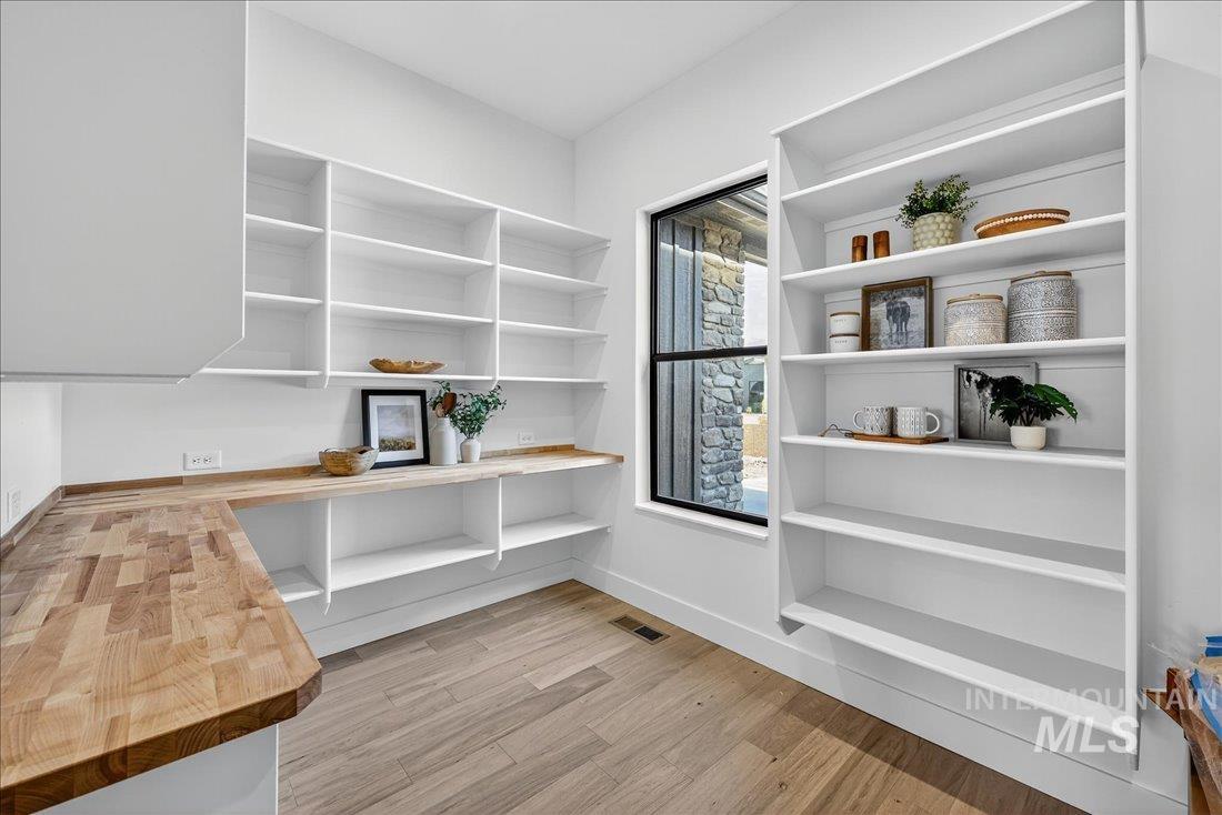 Unfurnished office with light wood-type flooring and baseboards