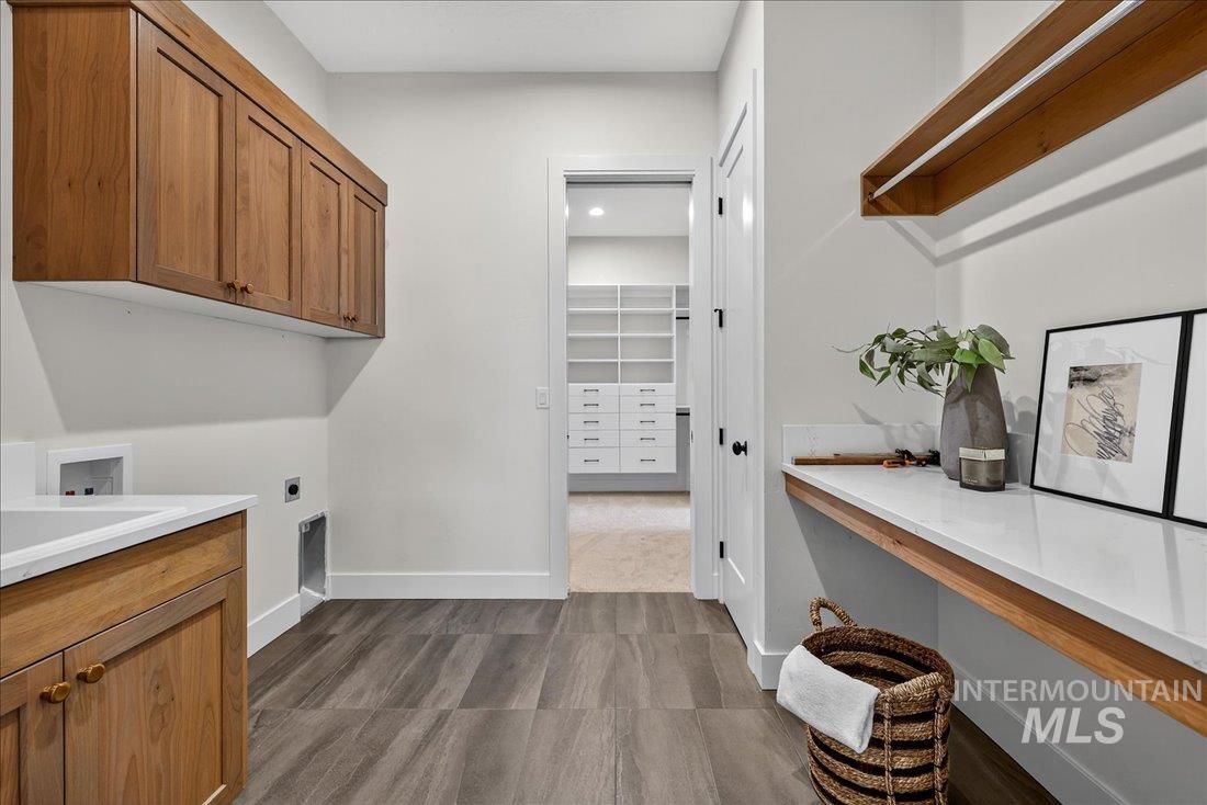 Laundry area with cabinet space and hookup for an electric dryer