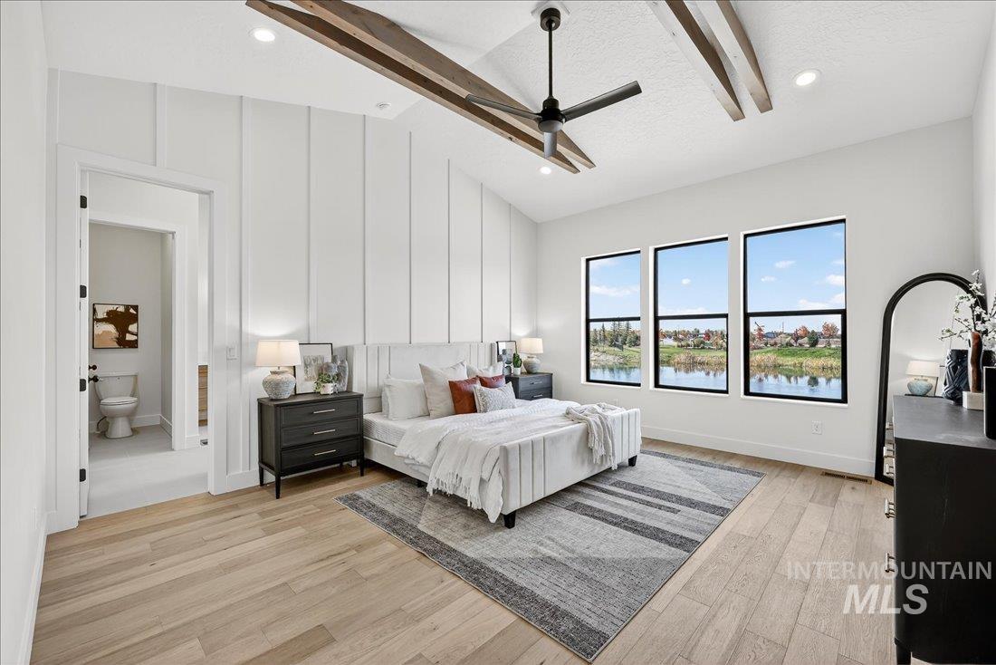 Bedroom with light wood-type flooring, a water view, recessed lighting, a ceiling fan, and a textured ceiling